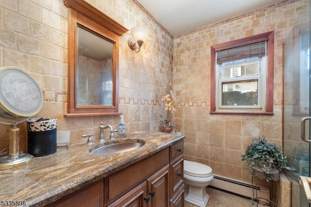 bathroom featuring toilet, an enclosed shower, baseboard heating, vanity, and tile walls