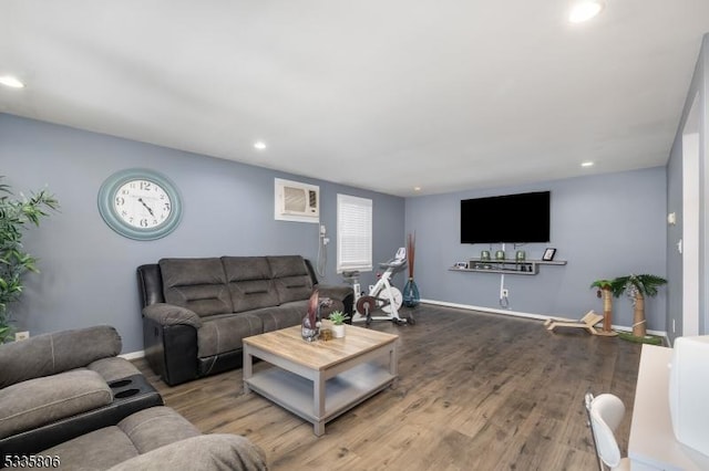 living room with baseboards, wood finished floors, and recessed lighting