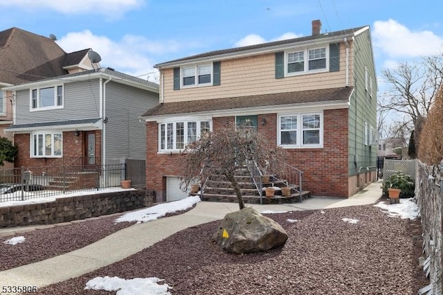 view of front of house featuring a garage, brick siding, fence, and a chimney