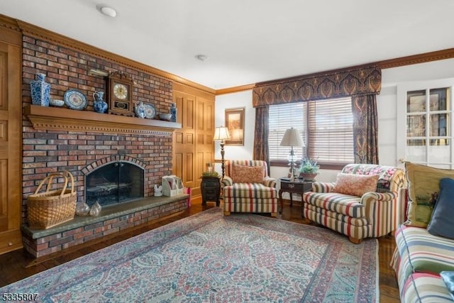 living room featuring crown molding, a fireplace, and hardwood / wood-style flooring