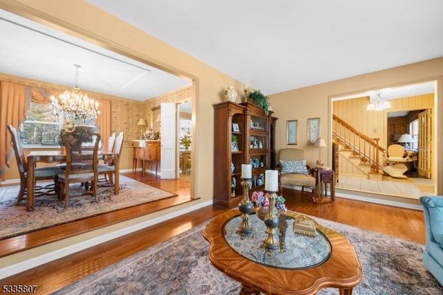 living area featuring a notable chandelier and hardwood / wood-style flooring