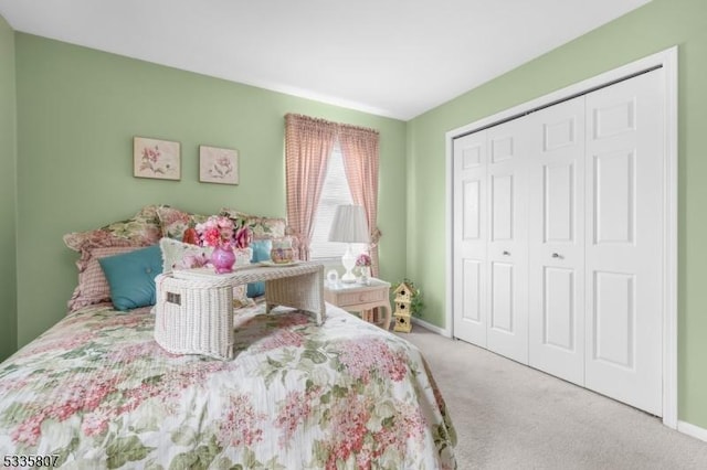 carpeted bedroom featuring a closet