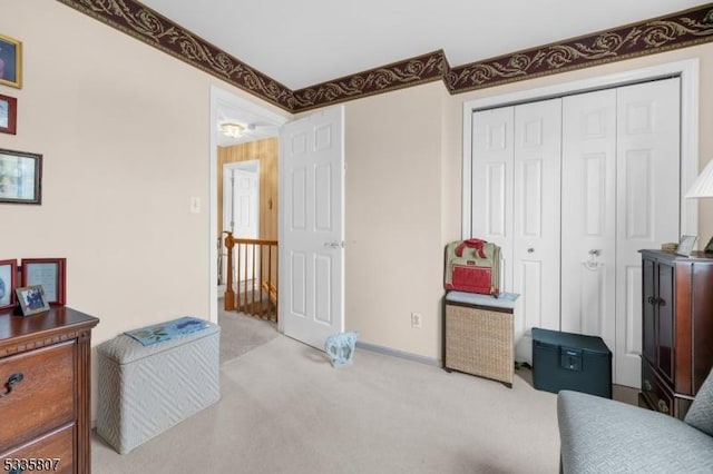 bedroom with light carpet and a closet