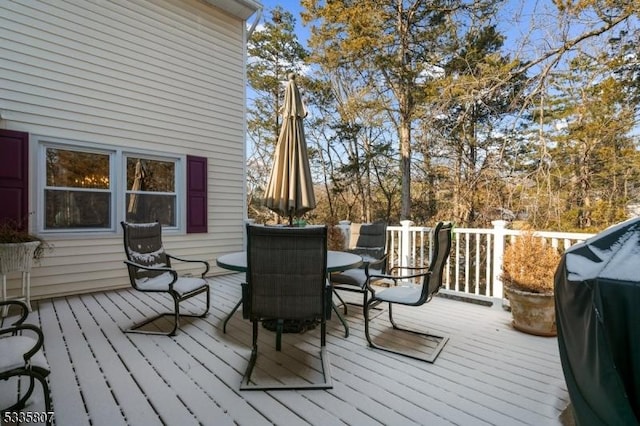 wooden deck featuring a grill