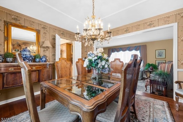 dining space with hardwood / wood-style flooring and a chandelier