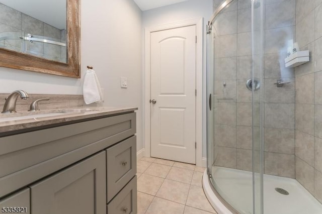 bathroom featuring vanity, tile patterned floors, and walk in shower