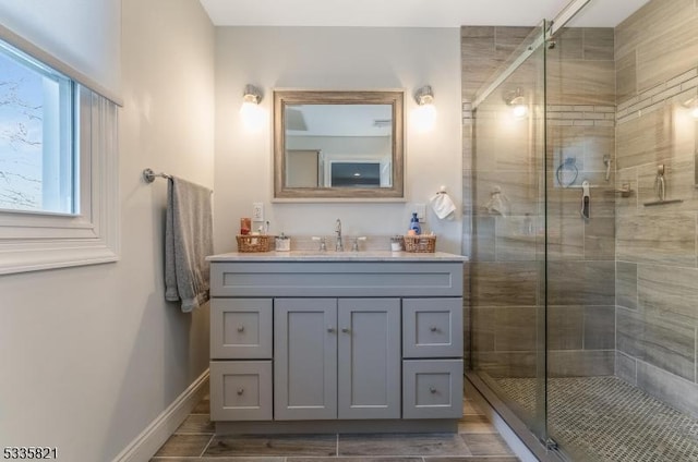 bathroom with vanity and a shower with shower door