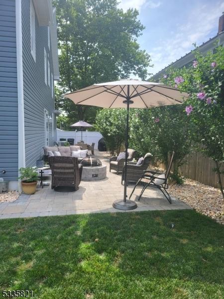 view of patio featuring an outdoor living space with a fire pit