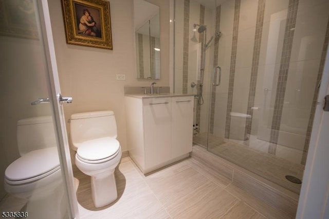 bathroom with vanity, toilet, and a shower with shower door