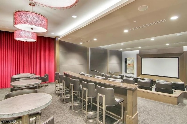 cinema room with indoor bar and carpet flooring