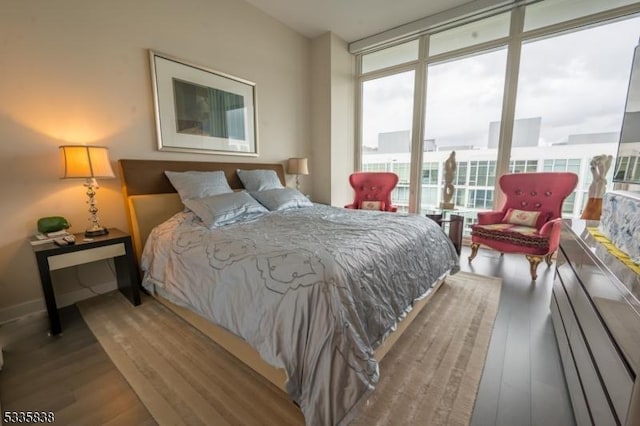 bedroom featuring hardwood / wood-style flooring and floor to ceiling windows