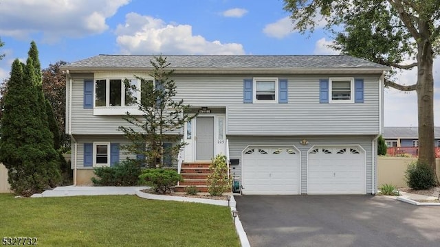 split foyer home featuring a garage and a front lawn