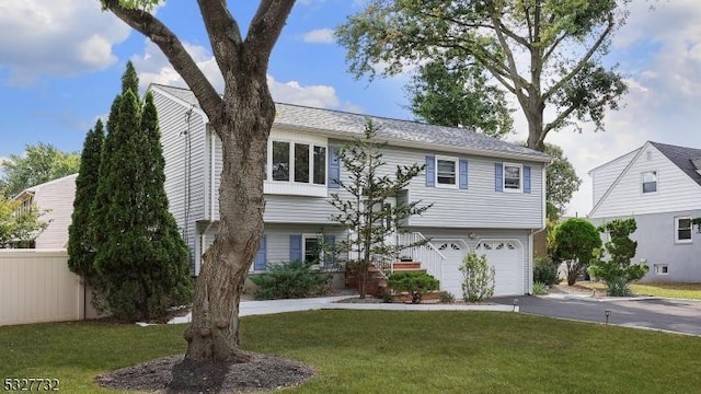 view of front of home with a garage and a front yard