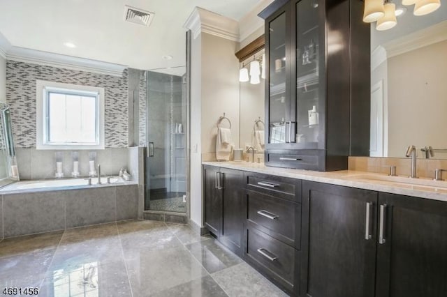 bathroom featuring ornamental molding, vanity, and shower with separate bathtub