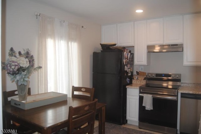 kitchen with black refrigerator, white cabinetry, stainless steel electric range oven, and light stone countertops