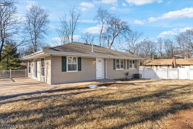 single story home with central AC unit, a front lawn, and fence