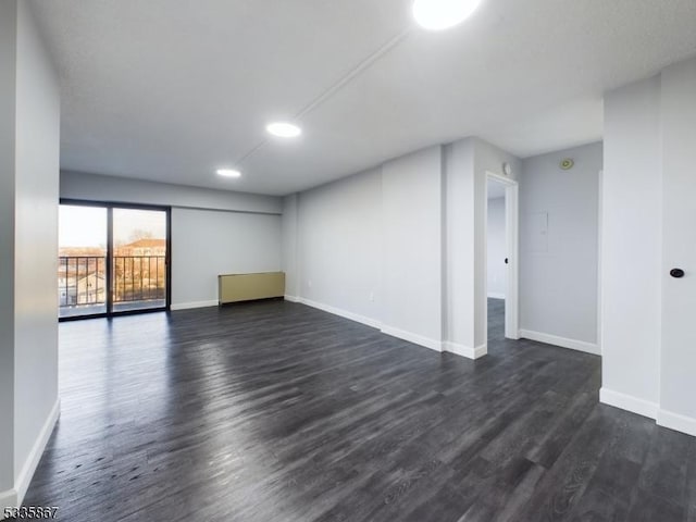 spare room featuring dark hardwood / wood-style flooring