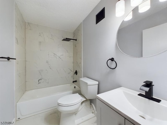 full bathroom featuring vanity, toilet, a textured ceiling, and tiled shower / bath