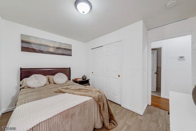 bedroom featuring a closet and light wood-type flooring