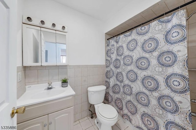 bathroom featuring tile walls, a shower with shower curtain, vanity, tile patterned floors, and toilet