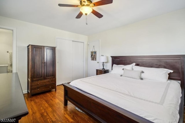 bedroom featuring ceiling fan, dark hardwood / wood-style flooring, and a closet