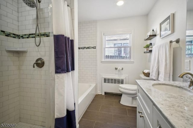 bathroom featuring radiator heating unit, toilet, curtained shower, and vanity