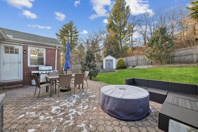 view of patio / terrace featuring grilling area, an outdoor living space, and a shed