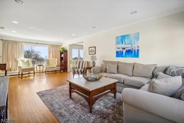 living room featuring hardwood / wood-style flooring and ornamental molding