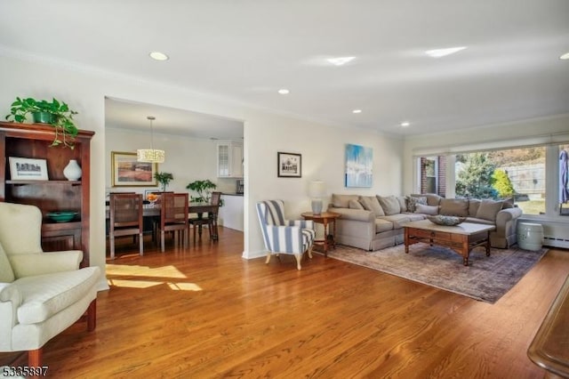 living room featuring ornamental molding and hardwood / wood-style floors