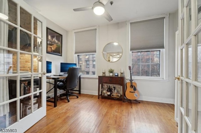 office space with french doors, ceiling fan, and wood-type flooring