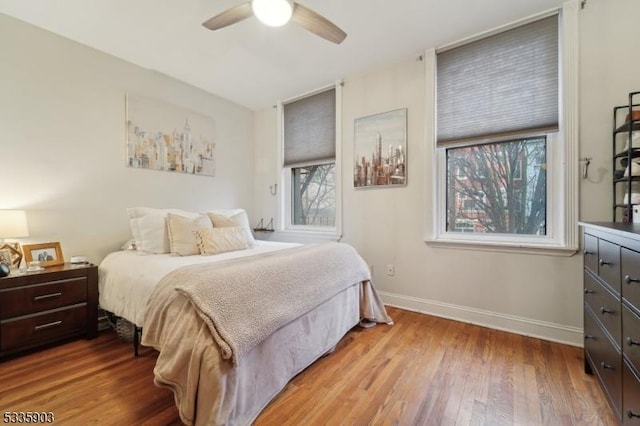 bedroom with ceiling fan and hardwood / wood-style floors