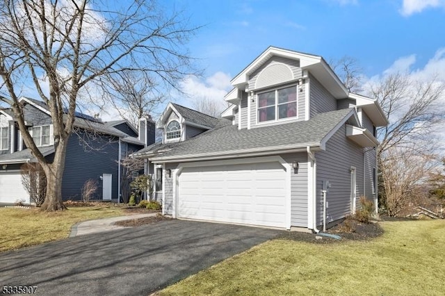 view of front facade with a garage, aphalt driveway, a front yard, and a shingled roof