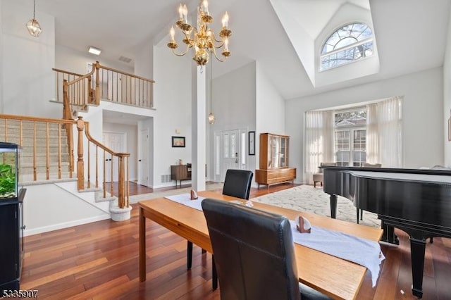 dining room featuring high vaulted ceiling, stairway, wood finished floors, and baseboards