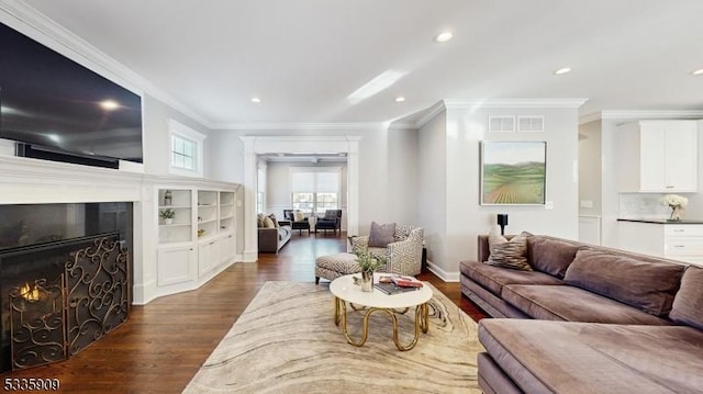 living room featuring ornamental molding and dark hardwood / wood-style floors