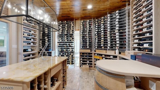 wine room featuring wood-type flooring and wooden ceiling