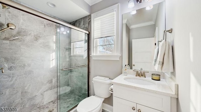 bathroom with vanity, ornamental molding, toilet, and walk in shower