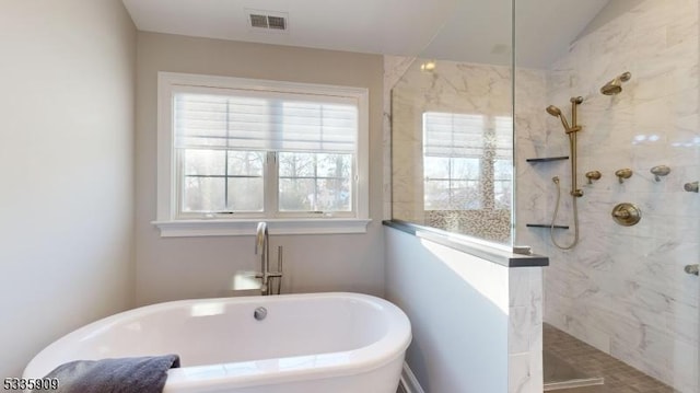 bathroom featuring separate shower and tub