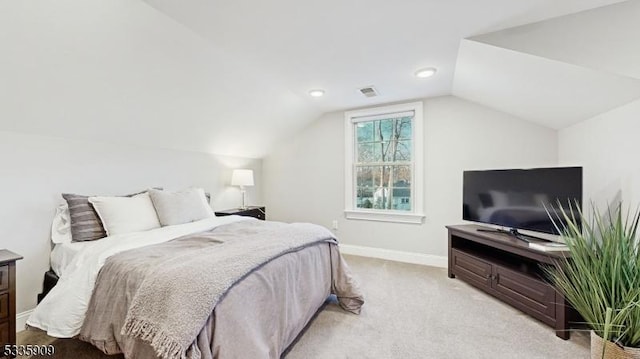 carpeted bedroom featuring lofted ceiling