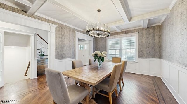 dining space with beam ceiling, coffered ceiling, a notable chandelier, ornamental molding, and dark hardwood / wood-style flooring