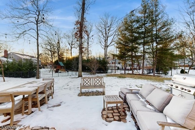 snowy yard featuring a playground