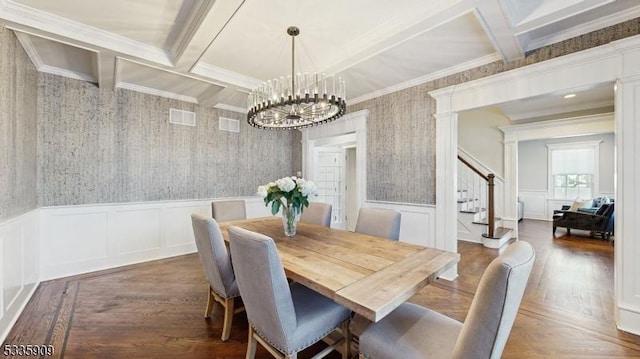 dining space with an inviting chandelier, ornamental molding, coffered ceiling, and beamed ceiling