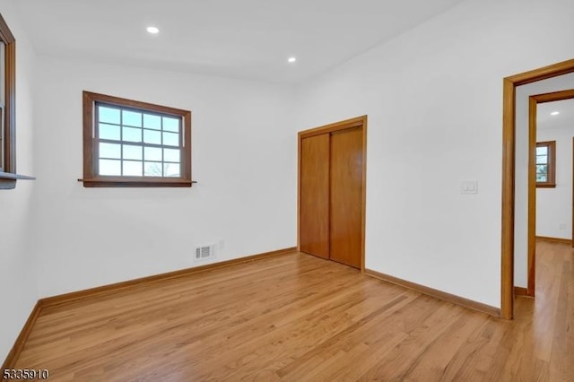 empty room with light hardwood / wood-style floors