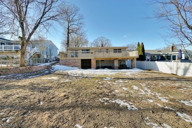 snow covered property featuring a wooden deck