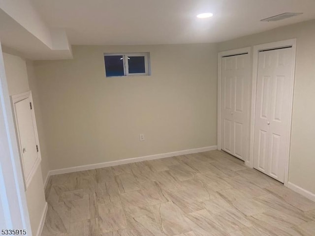 unfurnished bedroom featuring multiple closets