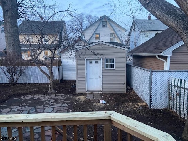 rear view of house featuring an outbuilding