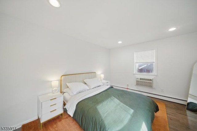 bedroom with recessed lighting, a wall mounted AC, baseboard heating, and wood finished floors