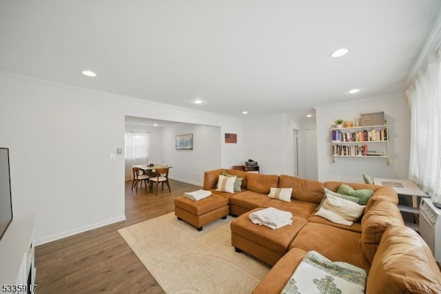 living area with ornamental molding, recessed lighting, baseboards, and wood finished floors