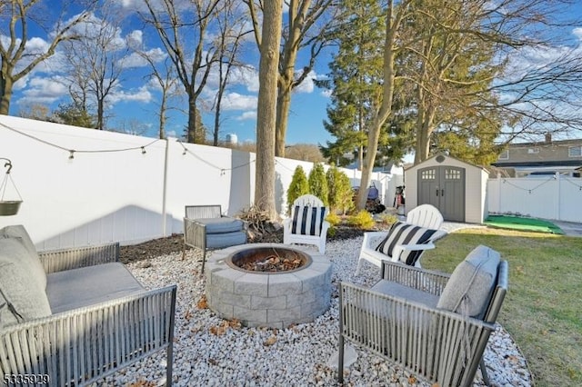 view of patio with a shed and an outdoor fire pit