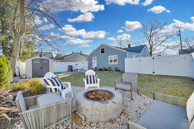 view of patio with a storage shed and an outdoor fire pit