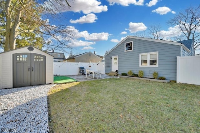 back of house featuring a patio, a shed, and a lawn